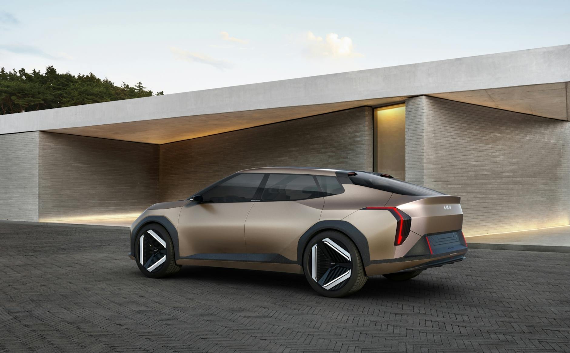 Sleek Kia concept electric vehicle parked in a modern architectural setting, showcasing design innovation.