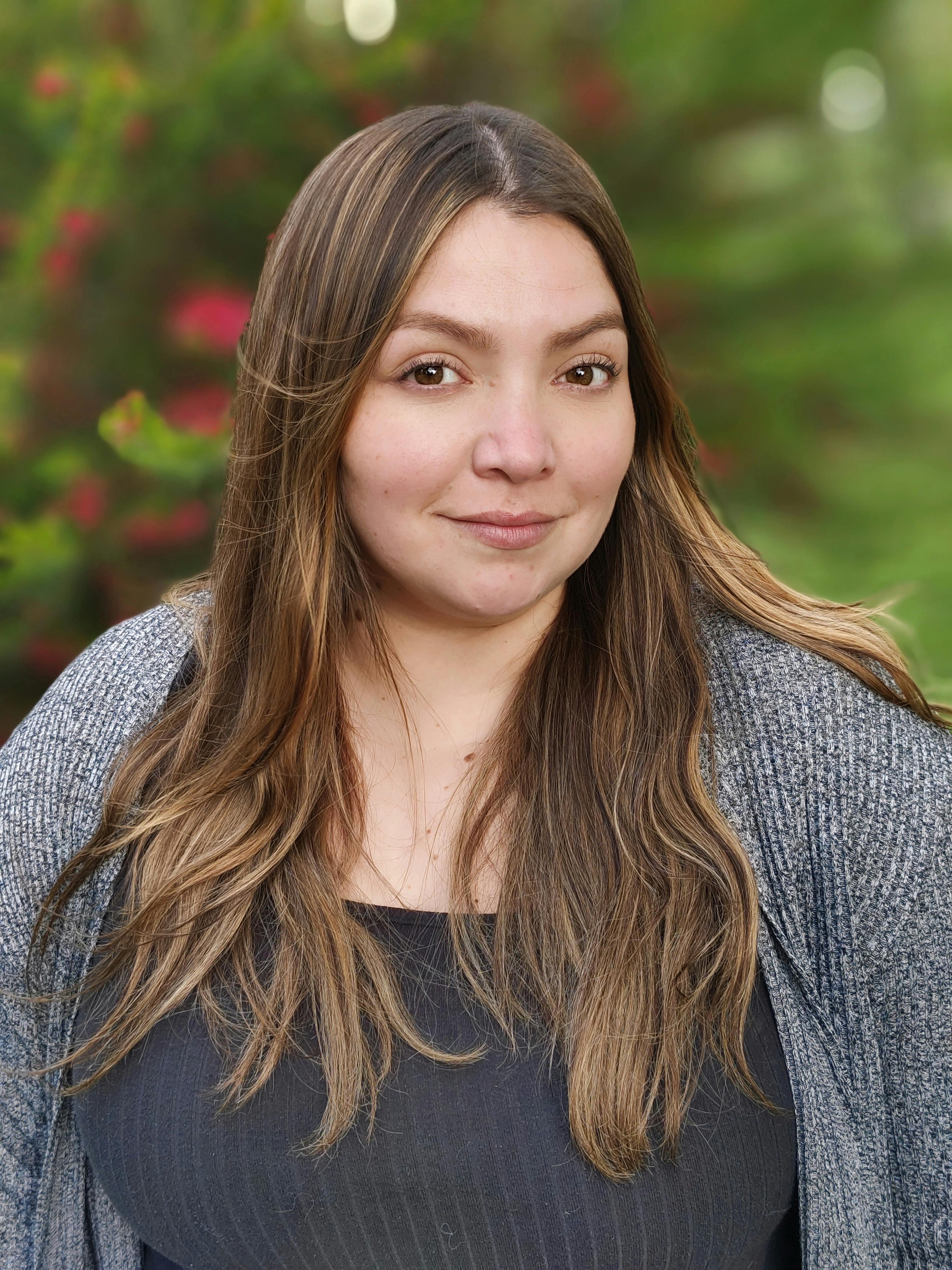 Portrait of a Woman with Long Brown Hair Wearing a Gray Cardigan · Free  Stock Photo