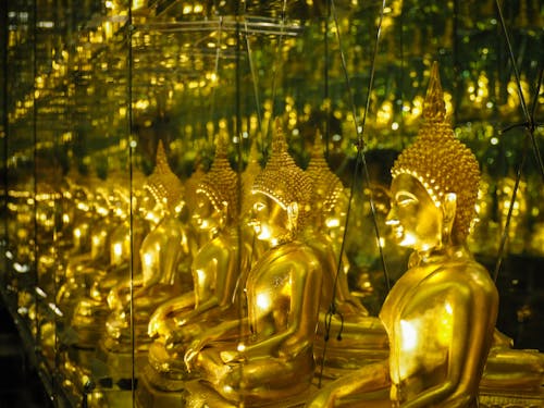 Multiple Reflections of a Golden Buddha Statue 