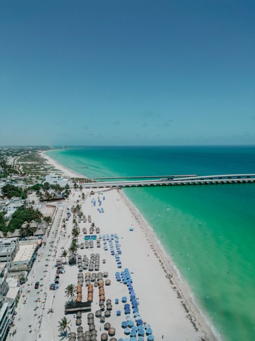 Free Stunning aerial view of Progreso Beach, Yucatan, with emerald waters and vibrant umbrellas. Stock Photo