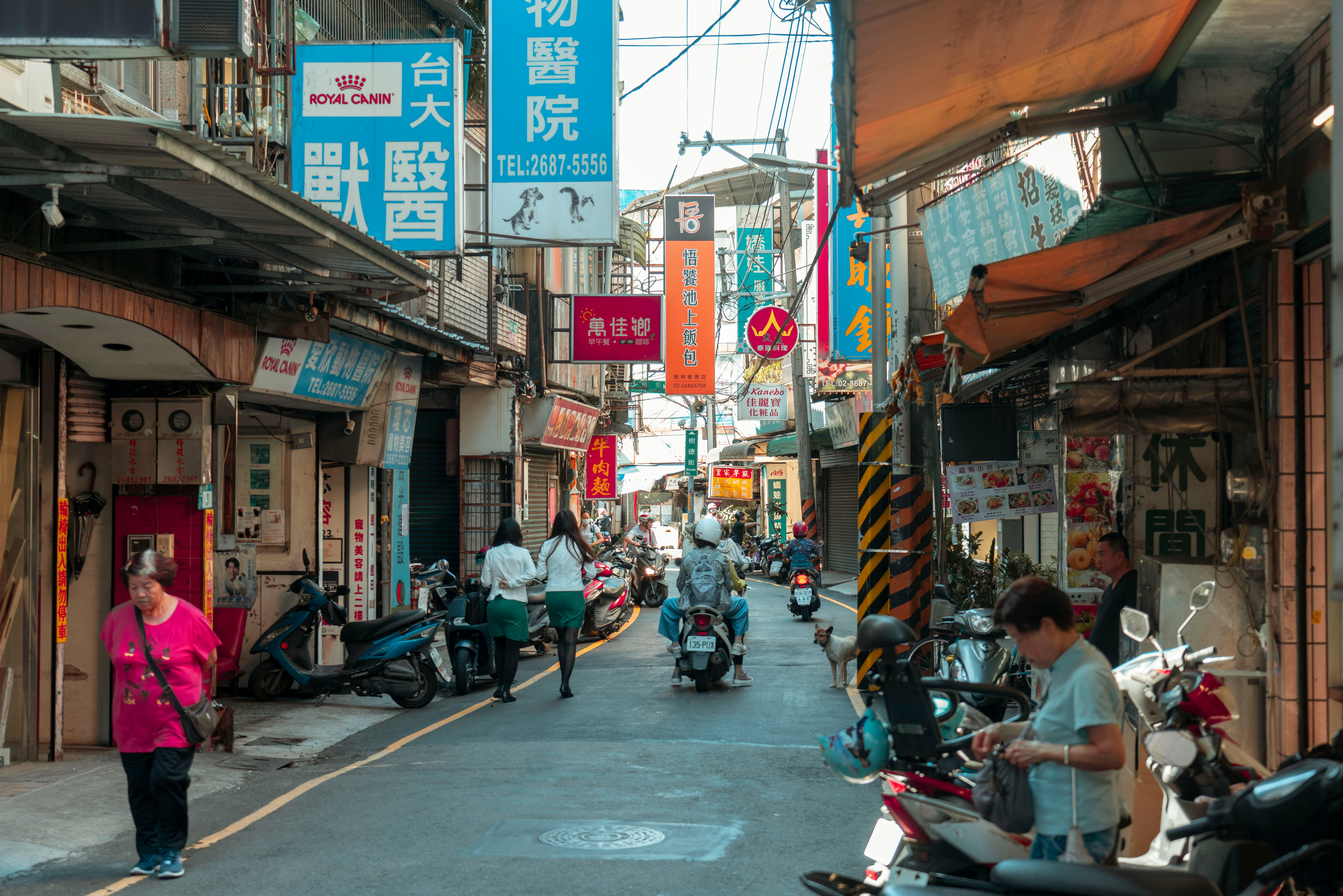 A Busy Street between Buildings in a Chinese City · Free Stock Photo