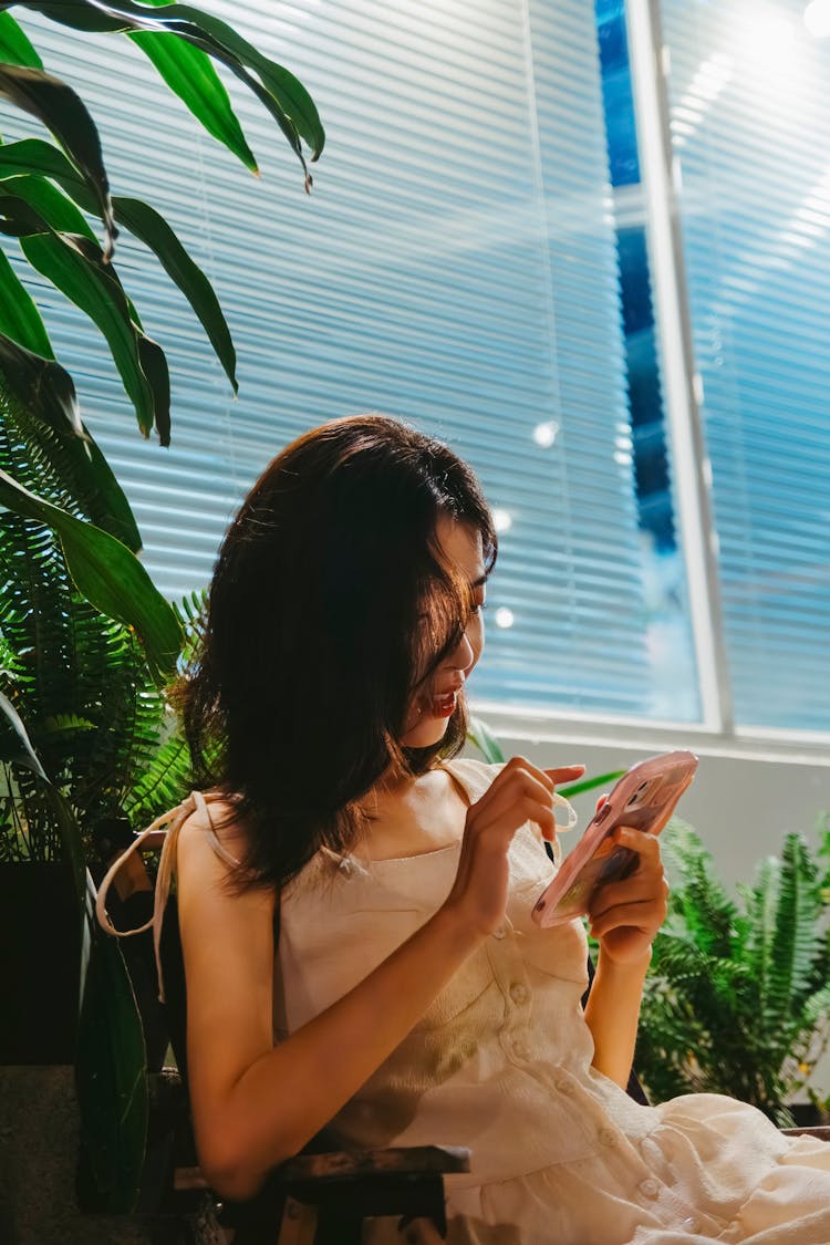 Woman Wearing White Dress Using Her Phone 