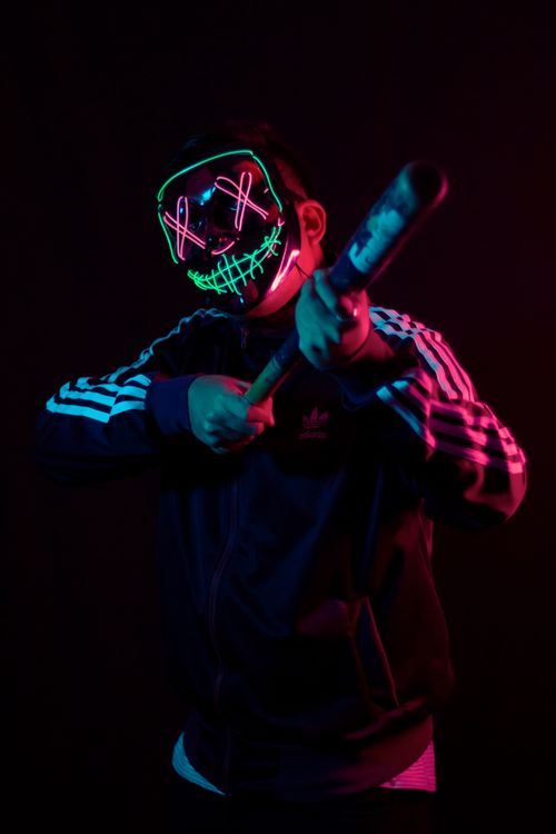 Masked Led Guy A Man Wearing an LED Halloween Mask and Holding a Baseball Bat · Free ...