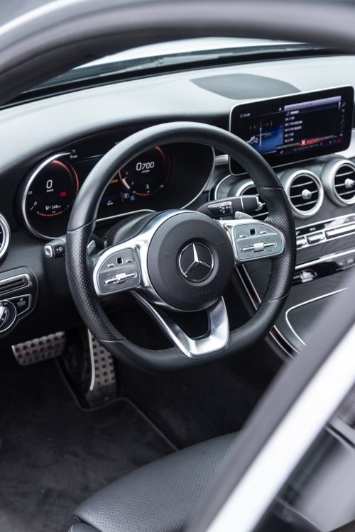 Free Close-up shot of a Mercedes Benz car dashboard and steering wheel featuring sleek design and modern technology. Stock Photo