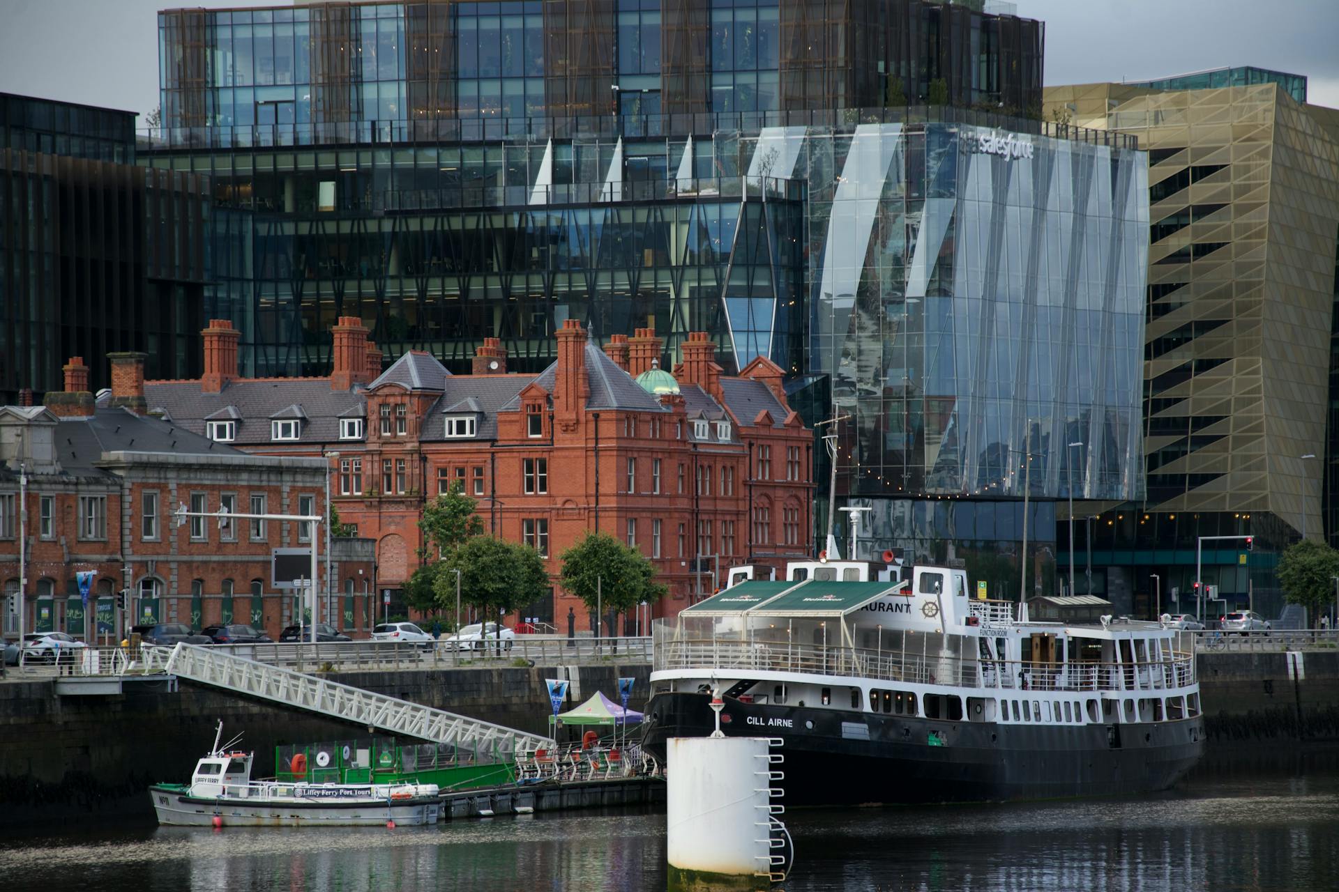 Explore the blend of modern glass structures and historic brick buildings at Dublin Docklands waterfront.