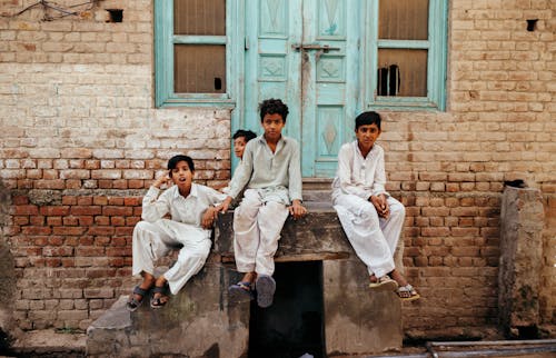 Boys Sitting on Doorway