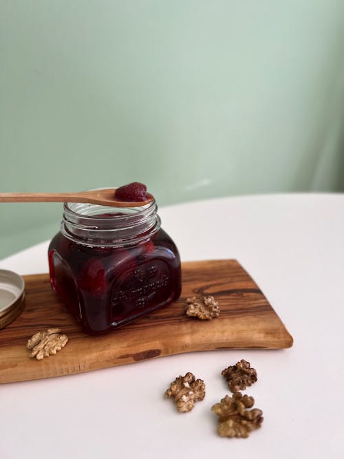 Strawberry Jam and Walnuts on a Cutting Board