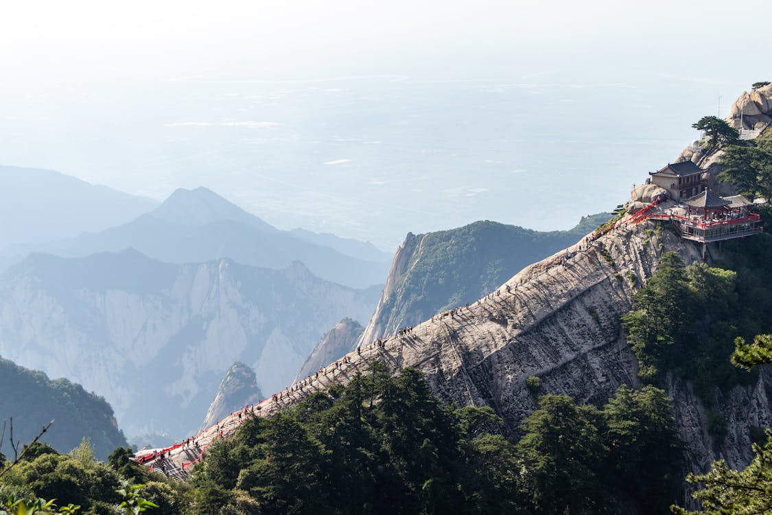 People Walking on Hill on Mountain Trail