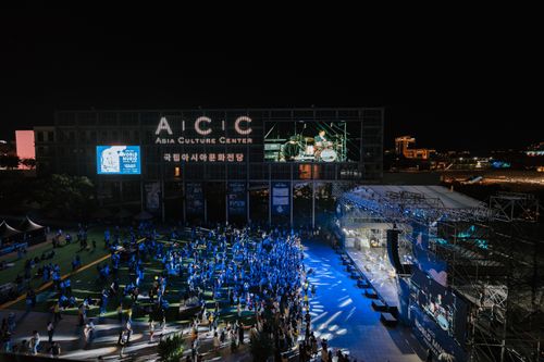 Free A vibrant night concert at Asia Culture Center with a lively crowd enjoying live music outdoors. Stock Photo