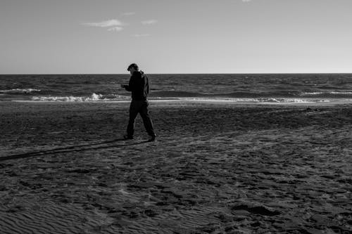 A Man Walking on the Beach 