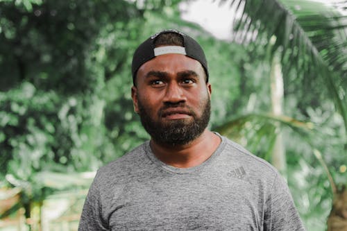 Man Wearing Cap and Adidas Shirt