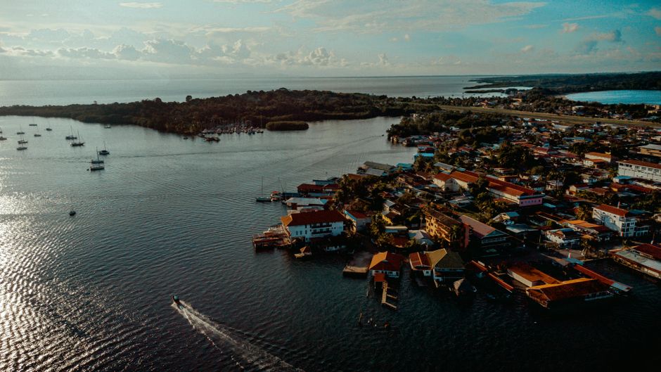 Water taxi approaching a stilted village in Bocas del Toro, Panama