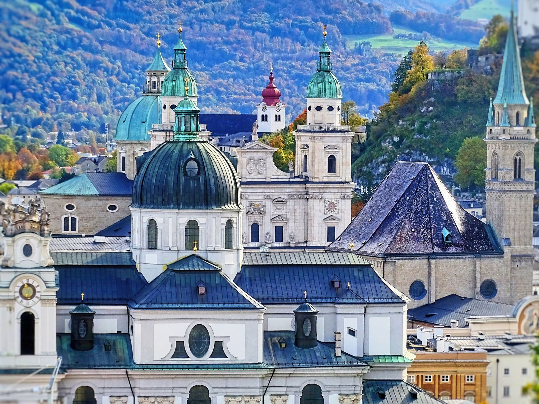 A picturesque view of Salzburg's iconic cathedrals with mountains in the background, showcasing cultural history.