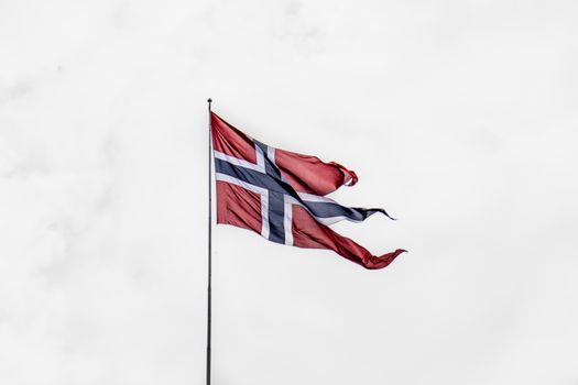 A norwegian flag flying in the wind