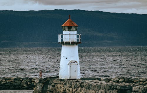 Lighthouse on Rocks in Port 