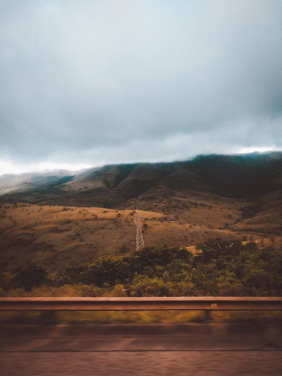 Scenic View Of Mountain Under Cloudy Sky