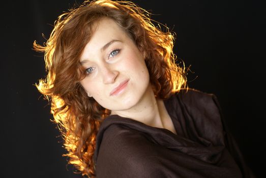 A woman with curly hair posing for a portrait