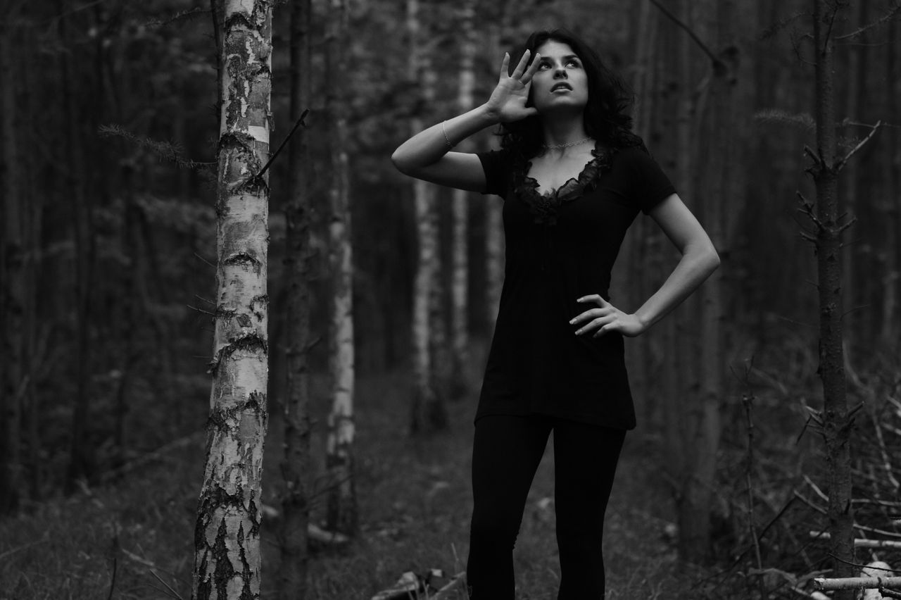 elegant black and white portrait of a woman posing thoughtfully in a f