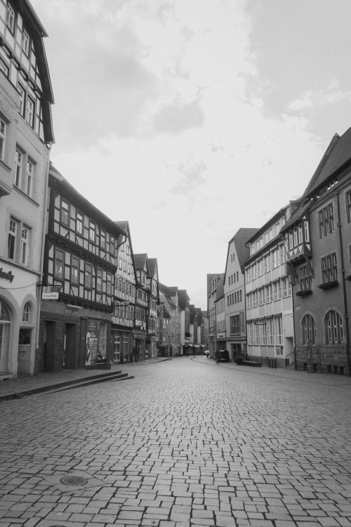 Free Charming black and white view of an old European town's cobblestone street. Stock Photo