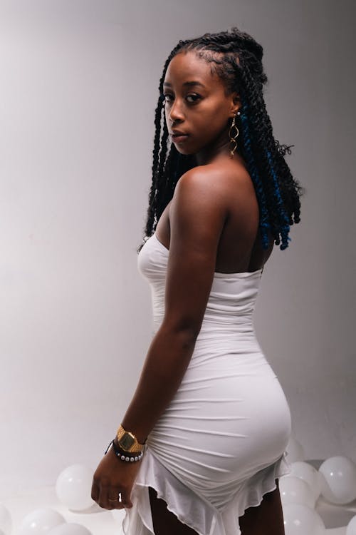 Studio Shot of a Young Woman Wearing a White Dress 