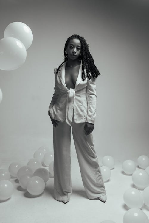 Woman Standing among Balloons in Black and White