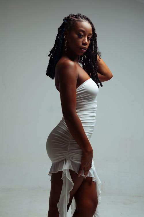 Studio Shot of a Young Woman in a White Dress 