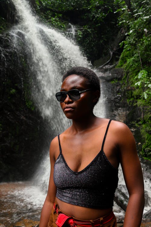 Portrait of Woman by Waterfall in Forest