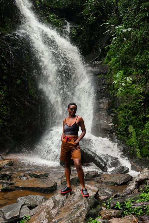 Woman Standing in front of a Waterfall · Free Stock Photo