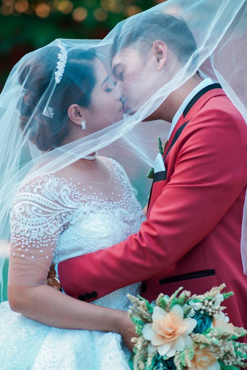 Newlyweds Kissing under Veil