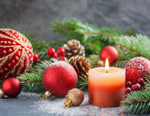 Free Christmas Decoration with Baubles and a Candle Stock Photo