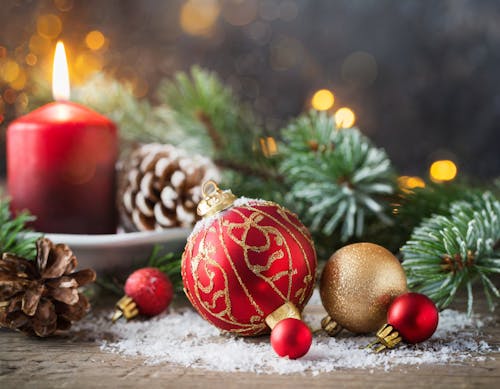 Free Christmas Decoration with Baubles, Cones, and a Candle Stock Photo