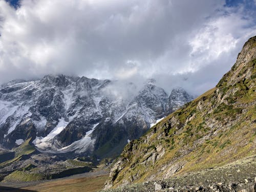 Slope of a Snow Covered Mountain with Peaks Hidden in the Cloud