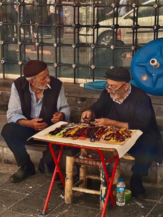 Senior Men Selling Prayer Beads on a Street