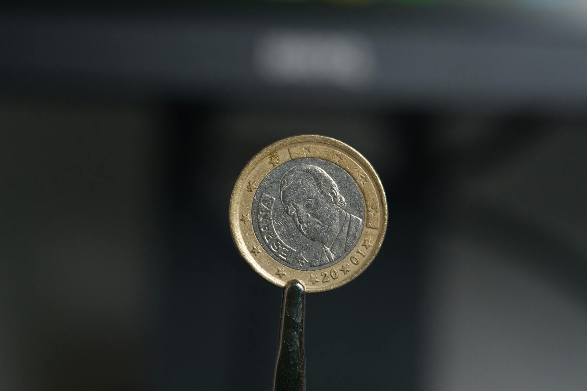 Spanish 1 Euro Coin from 2001 with the Image of King Miguel de Cervantes Held With Tweezers