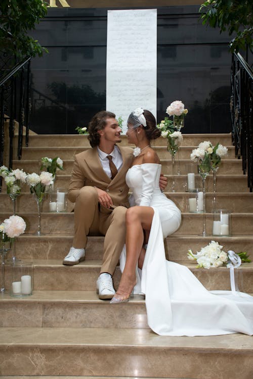 Newlyweds Sitting Together on Stairs