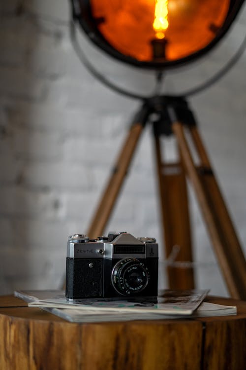 Analog Black Camera on Wooden Coffee Table