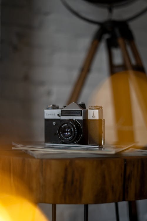 Analog Camera Lying on Wooden Coffee Table