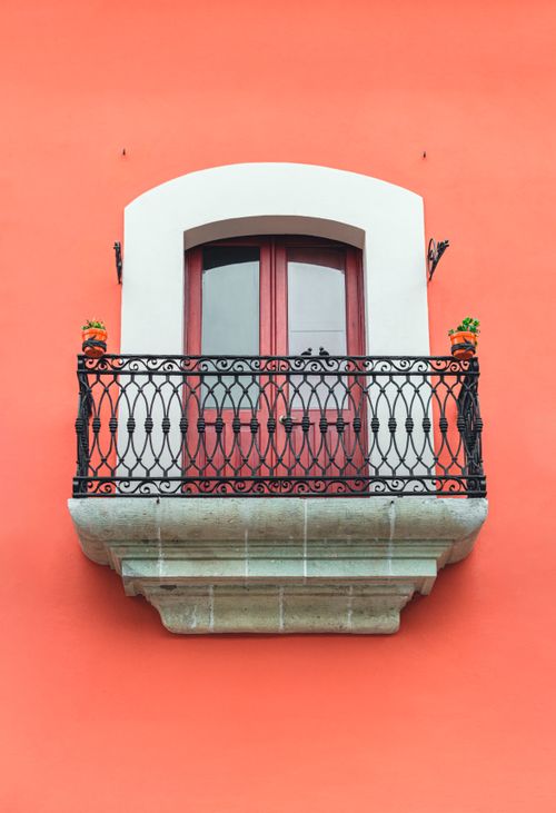 Free Beautiful red balcony against a vibrant wall in Oaxaca, showcasing Mexican architecture. Stock Photo