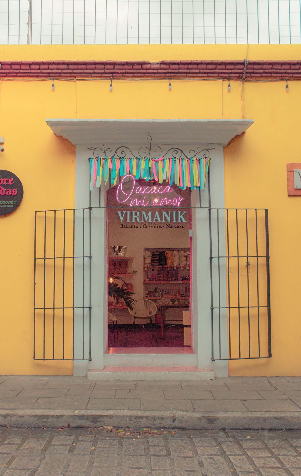 Charming storefront in Oaxaca city with vibrant decorations and inviting entrance.