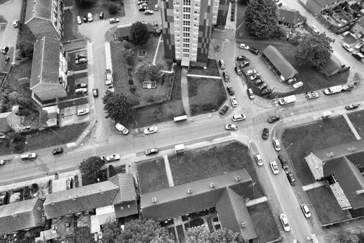 Black and white aerial shot of urban residential area in Luton, England with streets and cars visible.