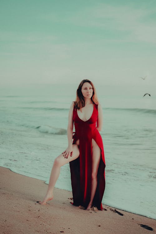 Woman in Red High Slit Dress on Beach