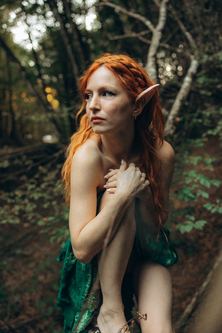 Redhead Elf Woman Sitting In Forest