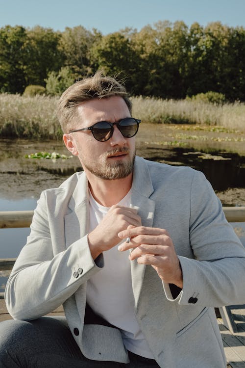 Portrait of Man in Suit and Sunglasses by Lake