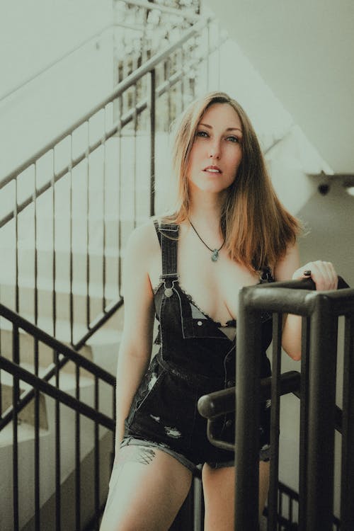 Woman in Overalls on Stairs