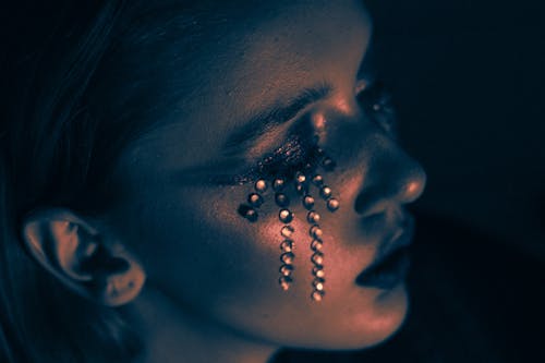 Woman with Glitter Teardrops on Face