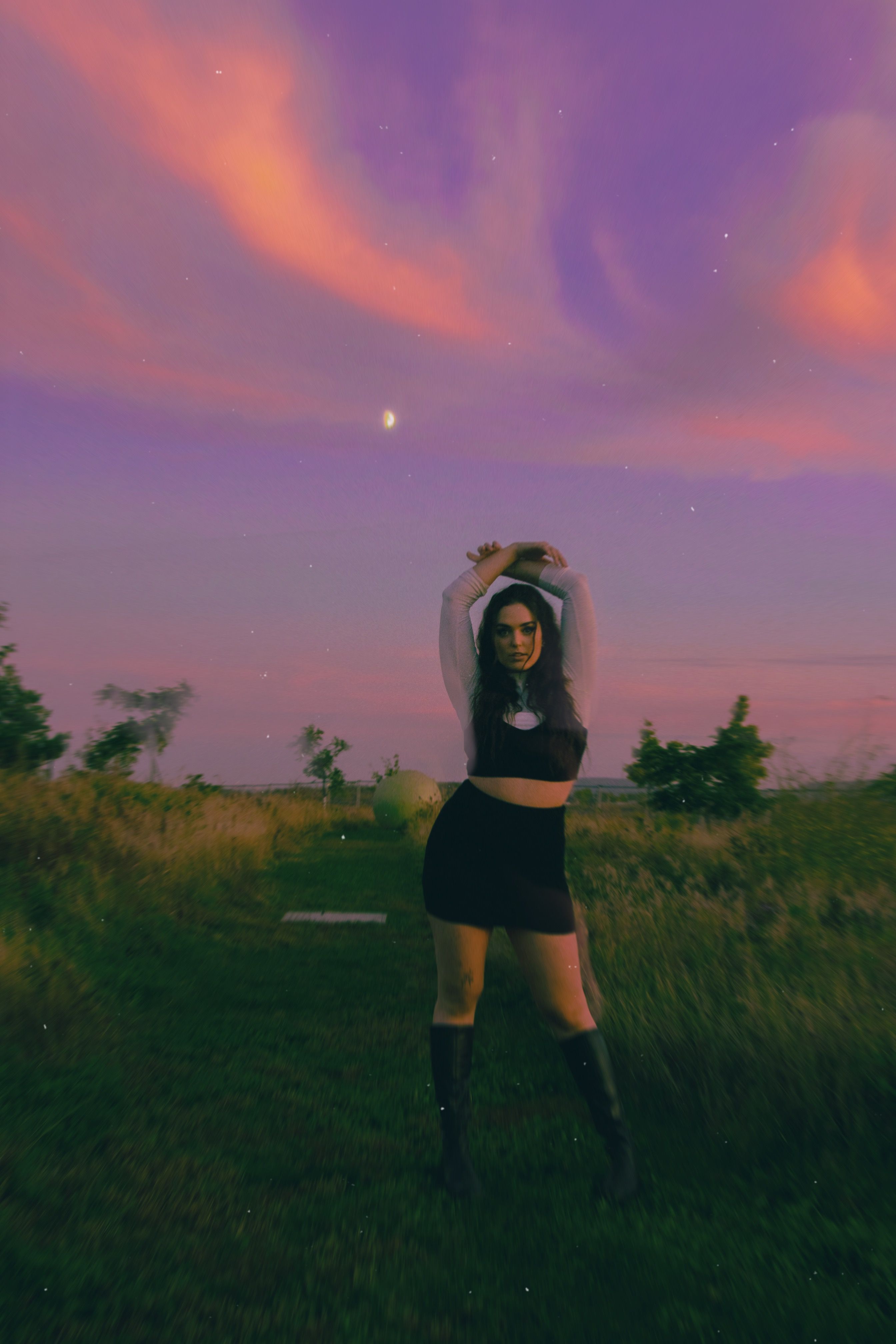 a-woman-posing-in-a-field-at-dusk-free-stock-photo