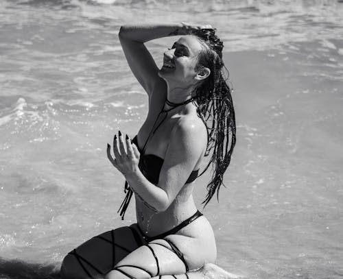 Brunette Model in Bikini Sitting in Water
