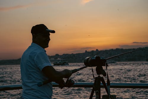 Fisherman on Sea Shore at Sunset