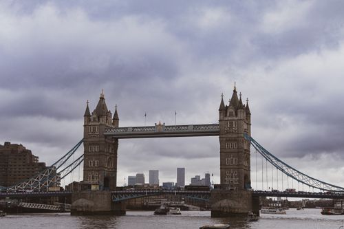 Free Scenic view of Tower Bridge over the River Thames in London with cloudy skies. Stock Photo