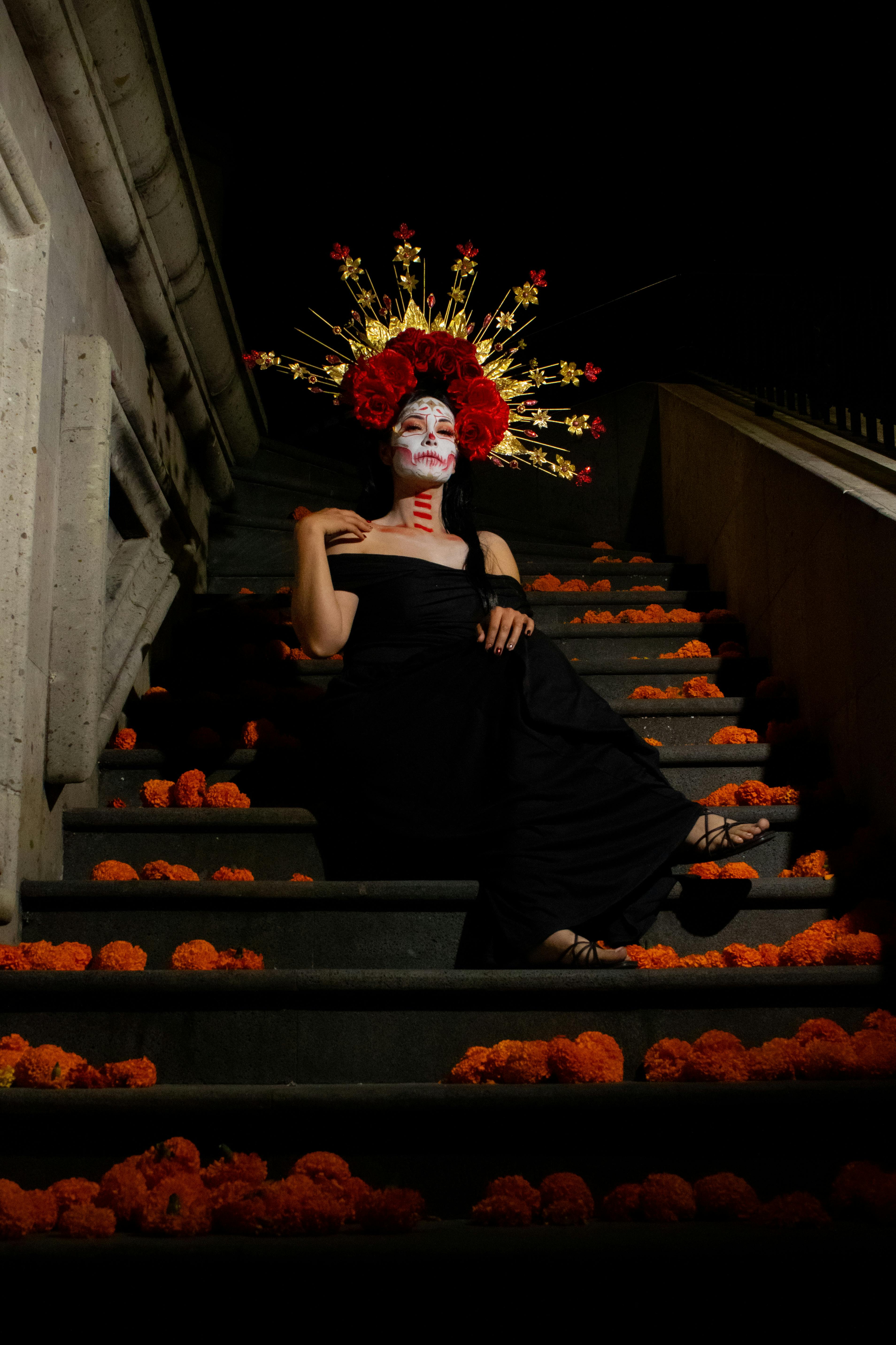 woman wearing traditional mexican costume sitting on stairs